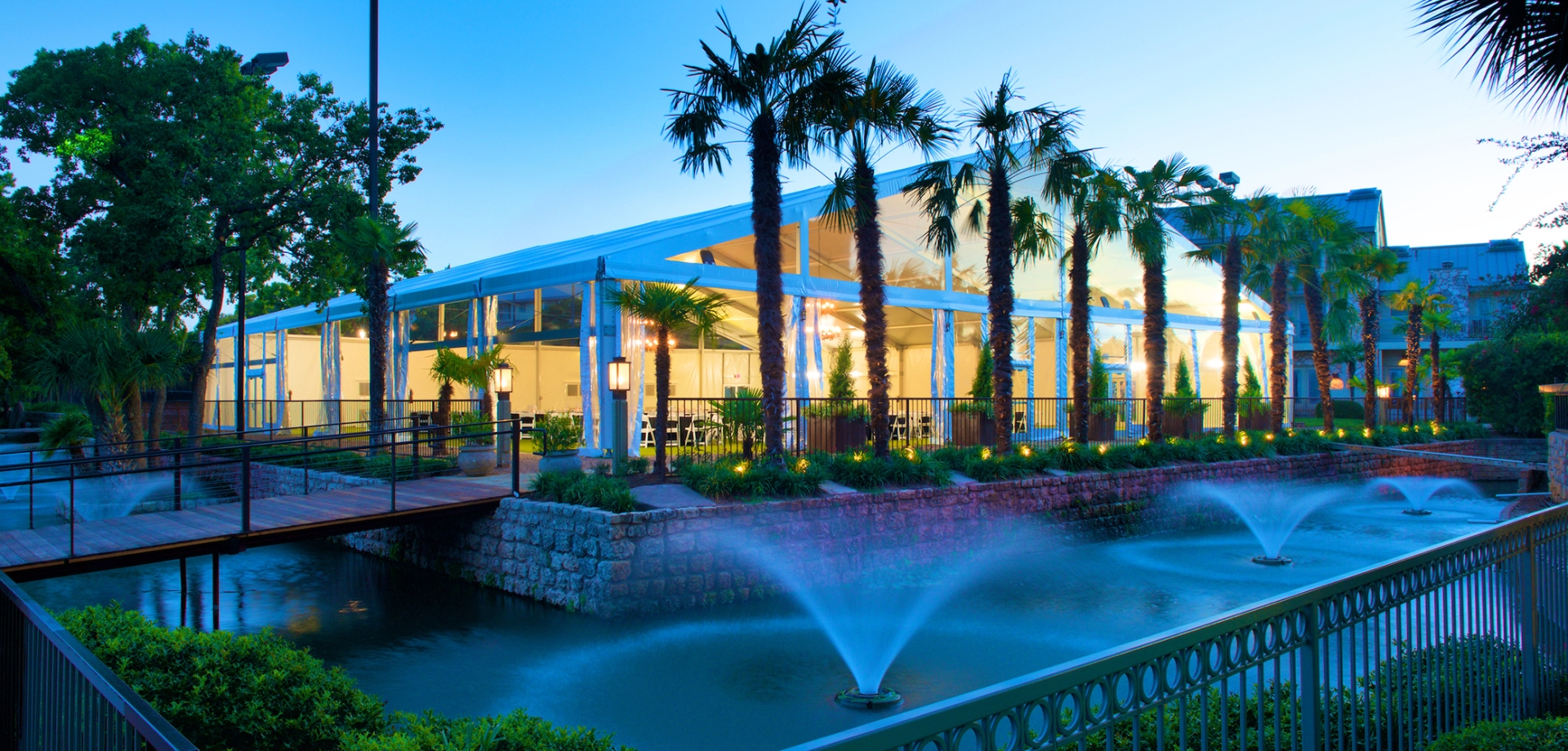 Large white tent for group events and parties overlooking a fountain.