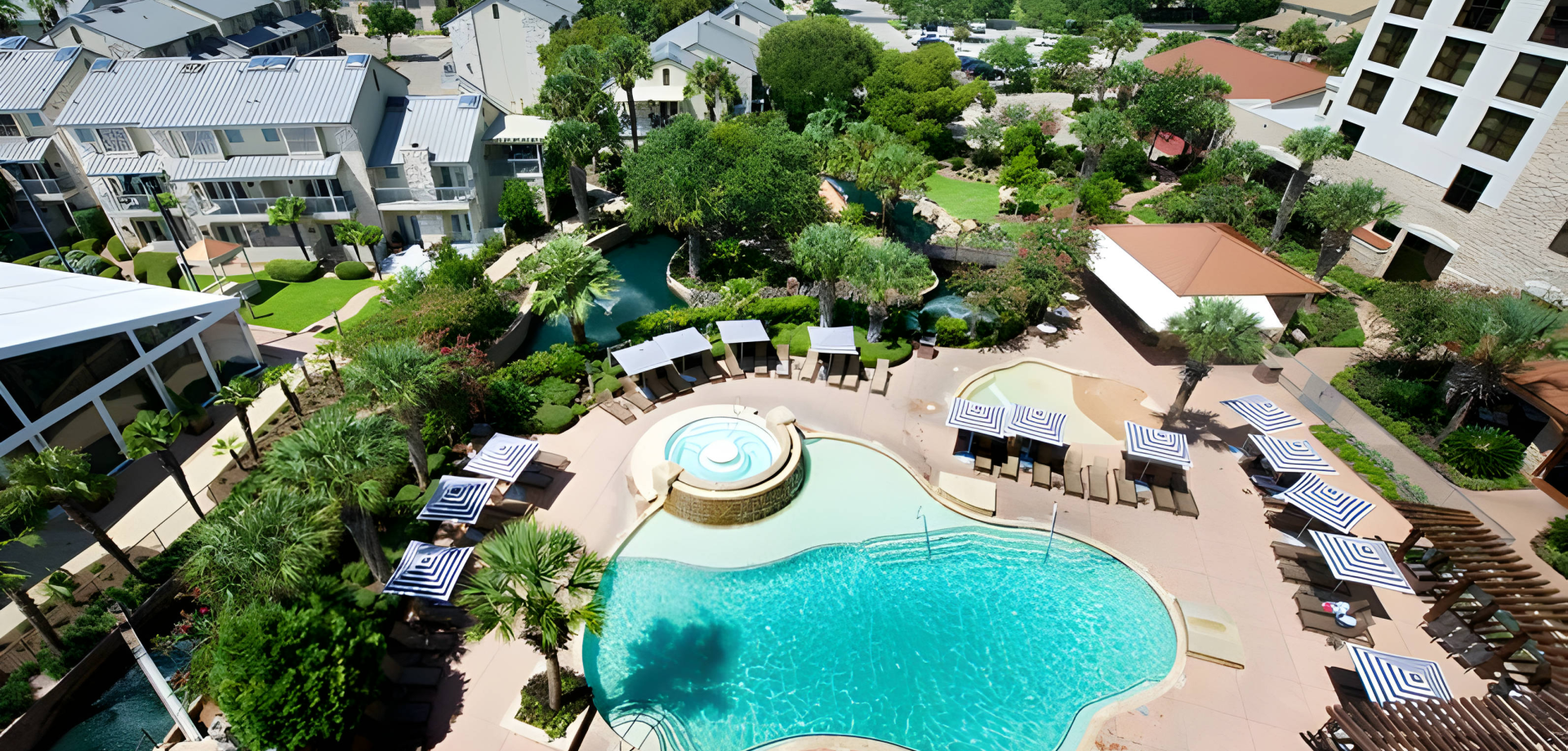 Birds eye view of Horseshoe Bay Resort Aviator pool surrounded by trees and the hotel.